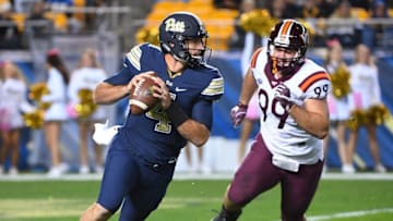 PITTSBURGH, PA - OCTOBER 27: Nathan Peterman No. 4 of the Pittsburgh Panthers scrambles to avoid the rush of Vinny Mihota No. 99 of the Virginia Tech Hokies in the first half during the game at Heinz Field on October 27, 2016 in Pittsburgh, Pennsylvania. (Photo by Justin Berl/Getty Images)