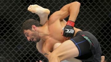Jul 25, 2015; Chicago, IL, USA; Andrew Holbrook (blue gloves) fights Ramsey Nijem (red gloves) during UFC Fight Night at United Center. Mandatory Credit: Dennis Wierzbicki-USA TODAY Sports