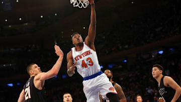 Jan 29, 2016; New York, NY, USA; New York Knicks forward Thanasis Antetokounmpo (43) reaches for the net over Phoenix Suns center Alex Len (21) during the fourth quarter at Madison Square Garden. New York Knicks won 102-84. Mandatory Credit: Anthony Gruppuso-USA TODAY Sports