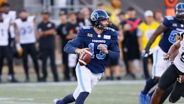 Michael O'Connor #13 of the Toronto Argonauts rolls out to pass against the Hamilton Tiger-Cats during a pre-season game at Tim Hortons Field. (Photo by John E. Sokolowski/Getty Images)
