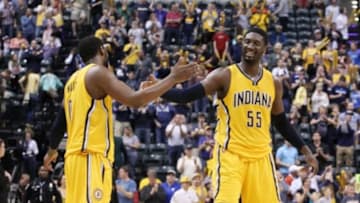 Apr 12, 2015; Indianapolis, IN, USA; Indiana Pacers guard C.J. Miles (0) celebrates the victory with center Roy Hibbert (55) after the game against the Oklahoma City Thunder at Bankers Life Fieldhouse. Indiana defeats Oklahoma City 116-104. Mandatory Credit: Brian Spurlock-USA TODAY Sports
