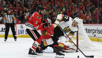 CHICAGO, ILLINOIS - OCTOBER 22: Max Pacioretty #67 of the Vegas Golden Knights battles Brent Seabrook #7 of the Chicago Blackhawks for a loose puck during the third period at the United Center on October 22, 2019 in Chicago, Illinois. (Photo by Stacy Revere/Getty Images)