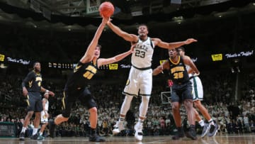 EAST LANSING, MI - DECEMBER 03: Luka Garza #55 of the Iowa Hawkeyes fight for a loose ball against Xavier Tilman #23 of the Michigan State Spartans in the second half at Breslin Center on December 3, 2018 in East Lansing, Michigan. (Photo by Rey Del Rio/Getty Images)