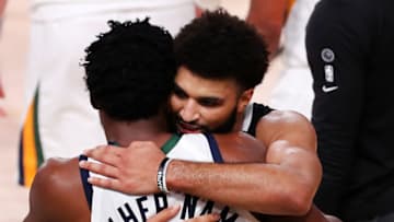 LAKE BUENA VISTA, FLORIDA - SEPTEMBER 01: Donovan Mitchell #45 of the Utah Jazz hugs Jamal Murray #27 of the Denver Nuggets after the game ends and the Denver Nuggets win in Game Seven of the Western Conference First Round during the 2020 NBA Playoffs at AdventHealth Arena at ESPN Wide World Of Sports Complex on September 01, 2020 in Lake Buena Vista, Florida. NOTE TO USER: User expressly acknowledges and agrees that, by downloading and or using this photograph, User is consenting to the terms and conditions of the Getty Images License Agreement. (Photo by Mike Ehrmann/Getty Images)