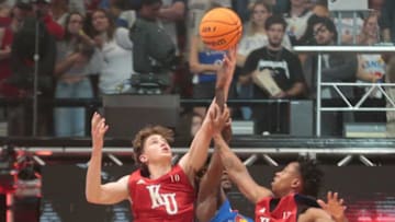 Kansas freshman guard Johnny Furphy (10) jumps for a rebound against freshman guard Jamari McDowell (11) and freshman guard Elmarko Jackson (13) during a scrimmage at Friday's Late Night in the Phog inside Allen Fieldhouse.