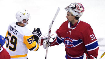 TORONTO, ONTARIO - AUGUST 07: Jake Guentzel #59 of the Pittsburgh Penguins congratulates Carey Price #31 of the Montreal Canadiens on the game and series win after Game Four of the Eastern Conference Qualification Round prior to the 2020 NHL Stanley Cup Playoffs at Scotiabank Arena on August 07, 2020 in Toronto, Ontario. (Photo by Andre Ringuette/Freestyle Photo/Getty Images)