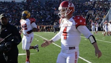Jan 25, 2014; Mobile, AL, USA; South squad quarterback Derek Carr of Fresno State (4) walks off the field after throwing a touchdown pass to South squad tight end Crockett Gilmore of Colorado State (not pictured) against the North squad during the first quarter at Ladd-Peebles Stadium. Mandatory Credit: John David Mercer-USA TODAY Sports