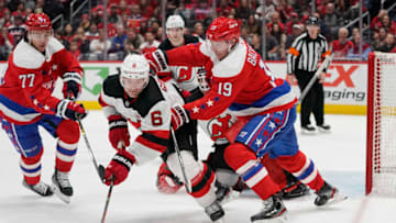 WASHINGTON, DC - JANUARY 11: Andy Greene #6 of the New Jersey Devils and Nicklas Backstrom #19 of the Washington Capitals battle for the puck in front of the net in the third period at Capital One Arena on January 11, 2020 in Washington, DC. (Photo by Patrick McDermott/NHLI via Getty Images)