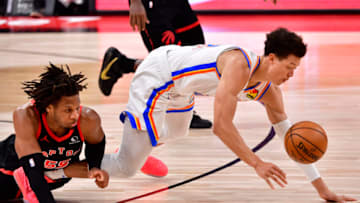 Freddie Gillespie #55 of the Toronto Raptors and Isaiah Roby #22 of the Oklahoma City Thunder fight for the ball during the third quarter at Amalie Arena on April 18, 2021 in Tampa, Florida.(Photo by Douglas P. DeFelice/Getty Images)