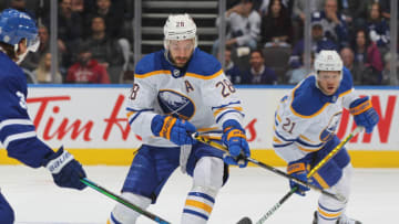 TORONTO, ON - APRIL 12: Zemgus Girgensons #28 of the Buffalo Sabres tries to handle a bouncing puck against the Toronto Maple Leafs during an NHL game at Scotiabank Arena on April 12, 2022 in Toronto, Ontario, Canada. The Sabres defeated the Maple Leafs 5-2. (Photo by Claus Andersen/Getty Images)