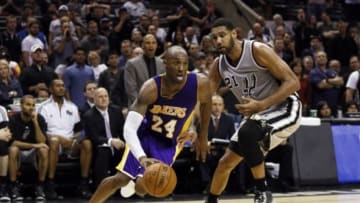 Dec 12, 2014; San Antonio, TX, USA; Los Angeles Lakers shooting guard Kobe Bryant (24) drives to the basket past San Antonio Spurs power forward Tim Duncan (21) during the second half at AT&T Center. The Lakers won 112-110 in overtime. Mandatory Credit: Soobum Im-USA TODAY Sports