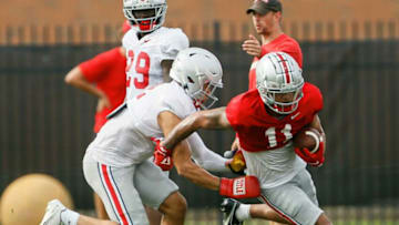 Ohio State Buckeyes safety Lathan Ransom (12) tries to tackle wide receiver Jaxon Smith-Njigba (11) while wearing boxing gloves during football training camp at the Woody Hayes Athletic Center in Columbus on Tuesday, Aug. 10, 2021.Ohio State Football Training Camp