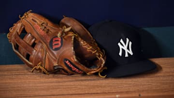 HOUSTON, TX - OCTOBER 20: A detail shot of a Wilson glove and Yankees cap in the dugout before Game 6 of the American League Championship Series between the New York Yankees and the Houston Astros at Minute Maid Park on Friday, October 20, 2017 in Houston, Texas. (Photo by Cooper Neill/MLB Photos via Getty Images)