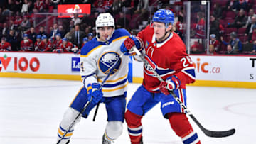 MONTREAL, CANADA - NOVEMBER 22: Dylan Cozens #24 of the Buffalo Sabres and Christian Dvorak #28 of the Montreal Canadiens skate against each other during the third period at Centre Bell on November 22, 2022 in Montreal, Quebec, Canada. The Buffalo Sabres defeated the Montreal Canadiens 7-2. (Photo by Minas Panagiotakis/Getty Images)