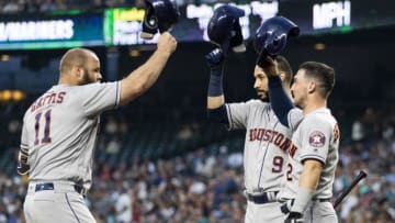SEATTLE, WA - JULY 31: Evan Gattis #11 of the Houston Astros taps batting helmets with Marwin Gonzalez #9 and Alex Bregman #2 (Photo by Lindsey Wasson/Getty Images)