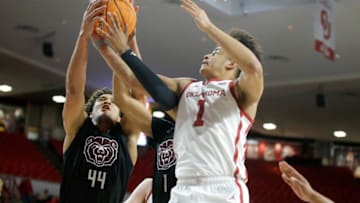 Oklahoma Sooners forward Jalen Hill (1) and Missouri State Bears forward Gaige Prim (44) reach for the ball during an NIT basketball game between at the University of Oklahoma Sooners (OU) and the Missouri State Bears at Lloyd Noble Center in Norman, Okla., Tuesday, March 15, 2022. Oklahoma won 89-72.Ou Nit Basketball
