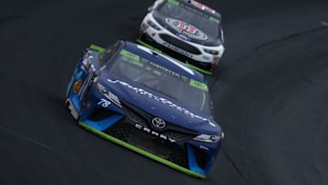 CHARLOTTE, NC - OCTOBER 08: Martin Truex Jr, driver of the #78 Auto-Owners Insurance Toyota, leads Kevin Harvick, driver of the #4 Jimmy John's Ford, during the Monster Energy NASCAR Cup Series Bank of America 500 at Charlotte Motor Speedway on October 8, 2017 in Charlotte, North Carolina. (Photo by Sarah Crabill/Getty Images)