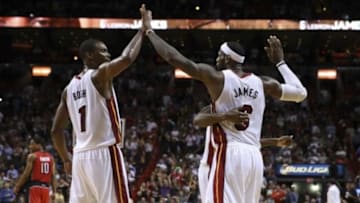 Mar 31, 2014; Miami, FL, USA; Miami Heat center Chris Bosh (1) and Miami Heat forward LeBron James (6) react in the second half of a game against the Toronto Raptors at American Airlines Arena. The Heat won 93-83. Mandatory Credit: Robert Mayer-USA TODAY Sports