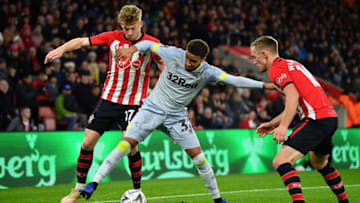 SOUTHAMPTON, ENGLAND - JANUARY 16: Jayden Bogle of Derby County is tackled by Stuart Armstrong (l) and James Ward-Prowse (r) of Southampton during the FA Cup Third Round Replay match between Southampton FC and Derby County at St Mary's Stadium on January 16, 2019 in Southampton, United Kingdom. (Photo by Dan Mullan/Getty Images)