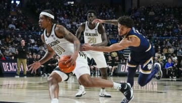 Feb 19, 2022; Winston-Salem, North Carolina, USA; Wake Forest Demon Deacons guard Alondes Williams (31) drives to the basket covered by Notre Dame Fighting Irish guard Prentiss Hubb (3) during the first half at Lawrence Joel Veterans Memorial Coliseum. Mandatory Credit: Jim Dedmon-USA TODAY Sports