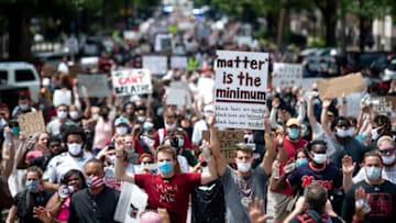 University of South Carolina quarterbacks Ryan Hilinski, left, and Jay Urich, march with protesters on Main St. (Photo by Sean Rayford/Getty Images)