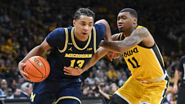 Jan 12, 2023; Iowa City, Iowa, USA; Michigan Wolverines guard Jett Howard (13) goes to the basket as Iowa Hawkeyes guard Tony Perkins (11) defends during the first half at Carver-Hawkeye Arena. Mandatory Credit: Jeffrey Becker-USA TODAY Sports