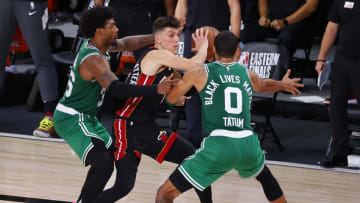 Tyler Herro #14 of the Miami Heat looks to pass against Jayson Tatum #0 of the Boston Celtics and Marcus Smart #36 of the Boston Celtics during the fourth quarter in Game Four. (Photo by Kevin C. Cox/Getty Images)