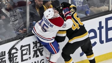 BOSTON - DECEMBER 1: Boston Bruins defenseman Matt Grzelcyk (48) checks Montreal Canadiens center Jesperi Kotkaniemi (15) into the boards during the third period. The Boston Bruins host the Montreal Canadiens in a regular season NHL hockey game at TD Garden in Boston on Dec. 1, 2019. (Photo by Matthew J. Lee/The Boston Globe via Getty Images)