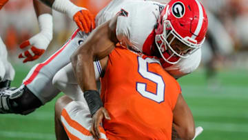 D.J. Uiagalelei is sacked by Quay Walker (7) during the first quarter at Bank of America Stadium. Mandatory Credit: Jim Dedmon-USA TODAY Sports