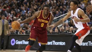 Feb 21, 2014; Toronto, Ontario, CAN; Cleveland Cavaliers forward Luol Deng (9) dribbles the ball around Toronto Raptors guard DeMar DeRozan (10) at Air Canada Centre. The Raptors won 98-91. Mandatory Credit: Tom Szczerbowski-USA TODAY Sports
