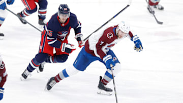 Apr 8, 2022; Winnipeg, Manitoba, CAN; Colorado Avalanche defenseman Devon Toews (7) skates past Winnipeg Jets center Mark Scheifele (55) in the third period at Canada Life Centre. Mandatory Credit: James Carey Lauder-USA TODAY Sports