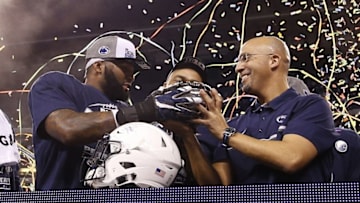 Dec 3, 2016; Indianapolis, IN, USA; Penn State Nittany Lions coach James Franklin holds up the trophy with linebacker Brandon Bell (11) after the game against the Wisconsin Badgers during the Big Ten Championship college football game at Lucas Oil Stadium. Penn State defeats Wisconsin 38-31. Mandatory Credit: Brian Spurlock-USA TODAY Sports