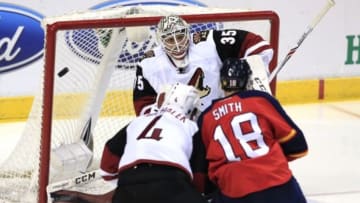 Feb 25, 2016; Sunrise, FL, USA; Arizona Coyotes goalie Louis Domingue (35) makes a save on a shot by Florida Panthers right wing Reilly Smith (18) as defenseman Zbynek Michalek (4) defends in the first period at BB&T Center. Mandatory Credit: Robert Mayer-USA TODAY Sports