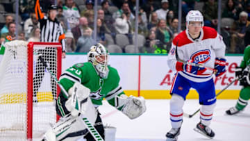 Jan 18, 2022; Dallas, Texas, USA; Dallas Stars goaltender Braden Holtby (70) and Montreal Canadiens center Nick Suzuki (14) in action during the game between the Montreal Canadiens and the Dallas Stars at the American Airlines Center. Mandatory Credit: Jerome Miron-USA TODAY Sports