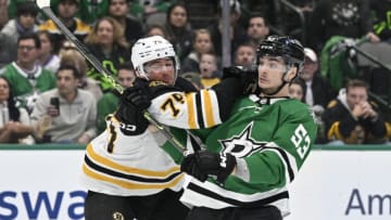 Feb 14, 2023; Dallas, Texas, USA; Boston Bruins defenseman Connor Clifton (75) checks Dallas Stars center Wyatt Johnston (53) during the overtime period at the American Airlines Center. Mandatory Credit: Jerome Miron-USA TODAY Sports