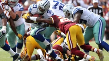 Sep 18, 2016; Landover, MD, USA; Dallas Cowboys running back Ezekiel Elliott (21) carries the ball as Washington Redskins cornerback Bashaud Breeland (26) attempts the tackle in the second quarter at FedEx Field. The Cowboys won 27-23. Mandatory Credit: Geoff Burke-USA TODAY Sports