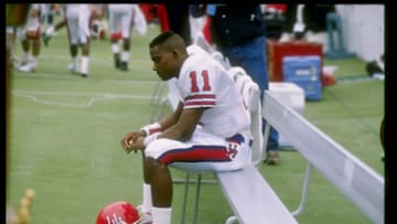 2 Dec 1989: Quarterback Andre Ware #11 of the Houston Cougars looks on during a game against the Rice Owls in Houston, Texas. The Houston Cougars won the game 64-0.
