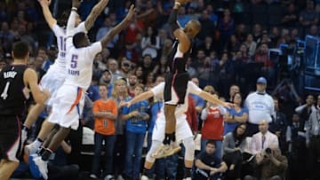 Nov 11, 2016; Oklahoma City, OK, USA; LA Clippers guard Chris Paul (3) shoots the ball over Oklahoma City Thunder guard Victor Oladipo (5) and Oklahoma City Thunder center Steven Adams (12) during the fourth quarter at Chesapeake Energy Arena. Mandatory Credit: Mark D. Smith-USA TODAY Sports