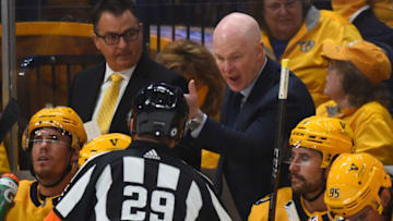Nashville Predators head coach John Hynes talks with referee Ian Walsh (29) against the Seattle Kraken at Bridgestone Arena. Mandatory Credit: Christopher Hanewinckel-USA TODAY Sports