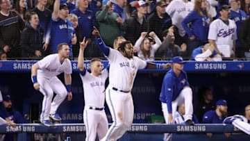 Vladimir Guerrero Jr. #27 of the Toronto Blue Jays celebrates their victory with Billy McKinney #28 and Ken Giles #51 as Brandon Drury #3 hit a game-winning two-run home run in the ninth inning during MLB game action against the Oakland Athletics at Rogers Centre. (Photo by Tom Szczerbowski/Getty Images)