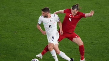 Italy's forward Domenico Berardi (L) with Turkey's defender Caglar Soyuncu (Photo by ANDREW MEDICHINI/POOL/AFP via Getty Images)