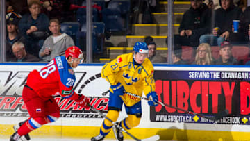 KELOWNA, BC - DECEMBER 18: Grigory Denisenko #28 of Team Russia stick checks Nils Höglander #21 of Team Sweden as he skates with the puck at Prospera Place on December 18, 2018 in Kelowna, Canada. (Photo by Marissa Baecker/Getty Images)