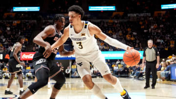 MORGANTOWN, WEST VIRGINIA - FEBRUARY 20: Tre Mitchell #3 of the West Virginia Mountaineers dribbles the ball during a college basketball game against the Oklahoma State Cowboys at the WVU Coliseum on February 20, 2023 in Morgantown, West Virginia. (Photo by Mitchell Layton/Getty Images)