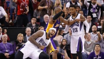 Dec 21, 2014; Sacramento, CA, USA; Sacramento Kings center DeMarcus Cousins (15) and Los Angeles Lakers guard Kobe Bryant (24) react after Cousins took a charge from Bryant for an offensive foul during the fourth quarter at Sleep Train Arena. The Sacramento Kings defeated the Los Angeles Lakers 108-101. Mandatory Credit: Kelley L Cox-USA TODAY Sports