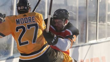 Feb 21, 2021; Stateline, Nevada, USA; Boston Bruins defenseman John Moore (27) is checked by Philadelphia Flyers defenseman Mark Friedman (3) during the first period in a NHL Outdoors hockey game at Lake Tahoe. Mandatory Credit: Kirby Lee-USA TODAY Sports