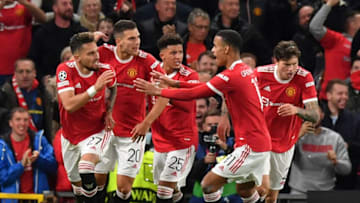 Manchester United's Brazilian defender Alex Telles (L) celebrates after scoring the equalising goal during the UEFA Champions league group F football match between Manchester United and Villarreal at Old Trafford stadium in Manchester, north west England, on September 29, 2021. (Photo by Anthony Devlin / AFP) (Photo by ANTHONY DEVLIN/AFP via Getty Images)