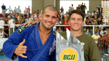 BUZIOS, BRAZIL - AUGUST 4: Rodolfo Vieira is awarded the first place trophy by Prefeito (Mayor) of Buzios Andre Granado after winning his match against Cassio Lisboa (not pictured) during the Brazilian Cup Jiu-Jitsu 2013 at the Buzios sports complex on August 4, 2013 in Buzios, Rio de Janeiro, Brazil. In 2013 Vieira won the World Championship in California and the World Cup in Abu Dhabi, UAE. (Photo by Joel Auerbach/Latin Content/Getty Images)