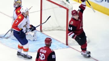 Mar 5, 2016; Glendale, AZ, USA; Arizona Coyotes left wing Alex Tanguay (40) celebrates with left wing Anthony Duclair (10) after scoring a goal as Florida Panthers defenseman Dmitry Kulikov (7) and goalie Al Montoya (35) react during the third period at Gila River Arena. Mandatory Credit: Matt Kartozian-USA TODAY Sports
