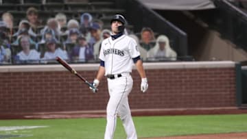 SEATTLE, WASHINGTON - AUGUST 03: Evan White #12 of the Seattle Mariners reacts after striking out in the ninth inning against the Oakland Athletics at T-Mobile Park on August 03, 2020 in Seattle, Washington. (Photo by Abbie Parr/Getty Images)