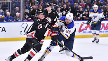 Nov 23, 2022; Buffalo, New York, USA; St. Louis Blues left wing Pavel Buchnevich (89) and Buffalo Sabres defenseman Henri Jokiharju (10) battle for the puck in the first period at KeyBank Center. Mandatory Credit: Mark Konezny-USA TODAY Sports